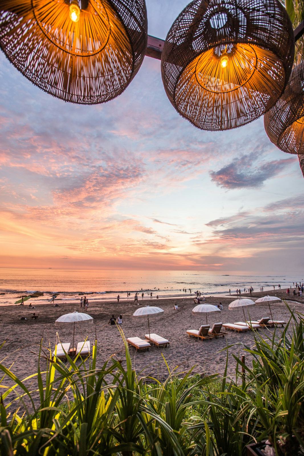 Beach club tepi pantai saat matahari terbenam